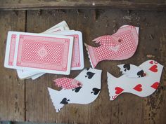 playing cards are laid out on a wooden table