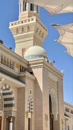 an ornate building with a large white umbrella over it