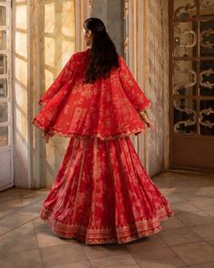 Editor's Note Introducing an exquisite cherry red floral and border printed hand-embroidered cotton silk lehenga set, paired with a print highlighted blouse and a net embroidered dupatta. Crafted from our signature print, this ensemble exudes elegance and charm. The intricate hand embroidery adds a touch of opulence and sophistication. Step into any special occasion with confidence, adorned in this captivating cherry red lehenga set that effortlessly combines traditional craftsmanship with conte Red Cotton Silk Sharara With Cutdana, Red Cotton Silk Sharara With Cutdana Details, Red Cotton Silk Sharara With Traditional Drape, Red Semi-stitched Cotton Silk Sharara, Red Cotton Silk Sets With Dupatta, Bollywood Style Red Cotton Silk Sharara, Festive Sharara With Printed Motifs For Reception, Red Embroidered Cotton Silk Sharara, Red Anarkali Sharara In Cotton Silk