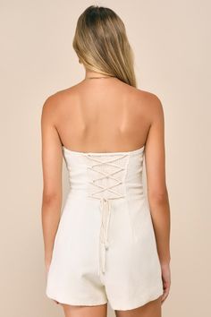 Show off your chicest side with your favorite blazer, flirty heels, and the Lulus Cute Expression Cream Jacquard Strapless Bustier Romper! Lightweight woven jacquard, with a raised weave-like pattern throughout, shapes this modish romper that boasts a strapless, bustier-inspired bodice with seamed cups, supportive boning, and a sweetheart neckline (with hidden no-slip strips). The fitted waist tops flirty shorts that feature seam detailing and a figure-flaunting fit. A trendy lace-up design and Chic Bandage Tube Top For Party, Spring Tube Top With Corset Back And Sweetheart Neckline, Chic Summer Tube Top With Boned Bodice, Summer Tube Top With Corset Back And Fitted Bodice, Summer Tube Top With Corset Back, Fitted Tube Top With Lined Bodice, Chic Lace Summer Tube Top, Chic Fitted Tube Top With Boned Bodice, Chic Lace Tube Top For Summer