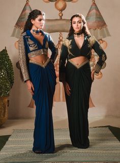 Introducing the paan petha set, a fusion outfit that blends traditional artistry with contemporary style. This captivating ensemble features a crop jacket, richly embroidered with zardozi, dabka, and moti work, reflecting the opulence of indian craftsmanship. The jacket is adorned with enchanting motifs like the son chidiya and berry bel, symbolizing grace and natural beauty, making this piece truly one-of-a-kind.The ensemble is completed with a draped skirt, designed with a flattering v-cut wai Blazer Traditional Dress, Fusion Dresses For Women, Unique Blazers Women, Fusion Wear Indian Western, Jacket Outfit Indian, Indian Western Fusion Fashion, Indian Fusion Outfits, Unique Indo Western Outfits For Women, Unique Indian Outfits