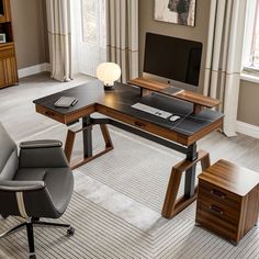 an office desk with two chairs and a computer monitor on top of it in front of a window