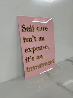 a pink sign that says self care isn't an expensive it's an investment