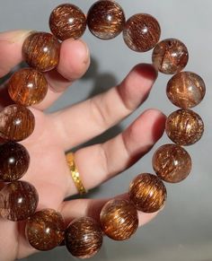 Material:Copper Rutilated Quartz  Gemstone size : Approx 13mm   quantity: one strand  6mm -apporx 62pcs beads 8mm -apporx 47pcs beads 10mm -apporx 37pcs beads 12mm -apporx 32pcs beads 14mm -apporx 28pcs beads 16mm -apporx 22pcs beads 18mm -apporx 20pcs beads 20mm -apporx 18pcs beads Energy Bracelets, Copper Red, Quartz Bracelet, Rutilated Quartz, Energy Healing, Jewelry Gifts, Copper, Jewelry Bracelets, Gems