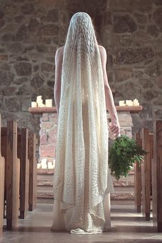 a woman in a wedding dress standing at the alter