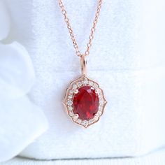 This elegant vintage style ruby diamond necklace features an oval shape ruby center surrounded by brilliant white diamonds set in the lustrous 14k gold vintage halo drop pendant that dangles beautifully from a solid gold cable chain. The length of the gold chain can be adjusted to either 16" or 18" long to suit your style! This oval ruby pendant can be crafted in your choice of white, rose, or yellow gold. ** The listing price is for one necklace only Availability: Ready to Ship: After the full Ruby Diamond Necklace, Ruby Diamond Pendant, Diamond Drop Pendant, Vintage Halo, Rose Gold Halo, Floral Halo, Oval Necklace, Ruby Pendant, Halo Pendant