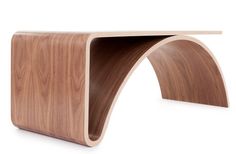 the curved wooden table is made out of wood