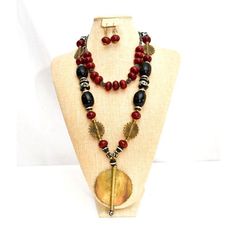 Beautiful black and maroon amber necklace with brass. Comes with matching earrings. Handmade Black Brass Necklace, Artisan Black Brass Jewelry, Black Bohemian Brass Necklace, Unique Black Brass Jewelry, Bohemian Black Brass Necklace, Traditional Brown Jewelry With Black Beads, Bronze Jewelry With Wooden Beads For Gift, Black Copper Bohemian Necklaces, Black Bohemian Copper Necklace