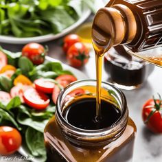 a jar filled with sauce sitting on top of a table next to tomatoes and spinach