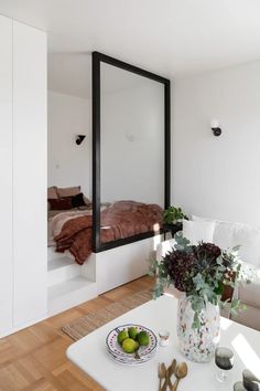 a living room filled with furniture and a large mirror