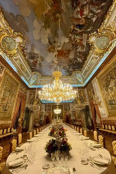 the dining room is decorated in gold and features elaborately painted ceilings, chandeliers, and ornate paintings