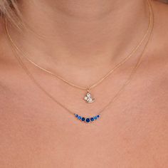 This stunning necklace features a delicate 14k gold chain with a graduated bezel design, adorned with beautiful blue sapphire gemstones. The pendant measures approximately 3/4 of an inch, making it the perfect size for everyday wear or special occasions. The combination of gold and sapphire creates a timeless and elegant look that will elevate any outfit. Diamond And Sapphire Necklace, Sapphire Diamond Necklace, Sapphire Pendant Necklace, Sapphire Diamond Pendant, Blue Sapphire Necklace, Bezel Necklace, Batman Arkham, Sapphire Pendant, Sapphire Necklace