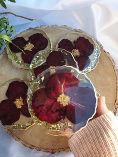 a person holding a plate with red flowers on it