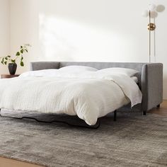 a bed sitting on top of a wooden floor