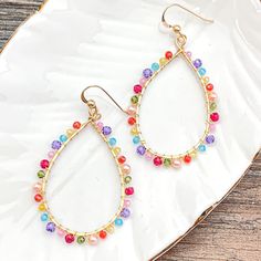 Colorful and light, everyday style hoops. 2” Trendy Rainbow Hoop Jewelry, Trendy Teardrop Earrings For Spring, Spring Trendy Teardrop Earrings, Trendy Colorful Hoop Jewelry, Trendy Small Hoop Earrings With Colorful Beads, Trendy Multicolor Hoop Earrings With Ear Wire, Trendy Multicolor Hoop Earrings As Gift, Trendy Dangle Hoop Earrings For Spring, Trendy Spring Dangle Hoop Earrings