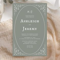 an elegant wedding card with the word, ashlight and jenny written in white on it