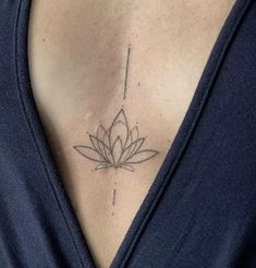 a woman with a lotus tattoo on her chest