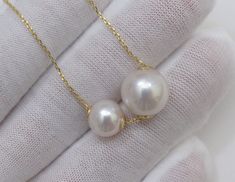 Material : Two Genuine Natural Edison White Round Pearls with 925 Sterling Gold Chain Quantity : One Necklace with Chain Shape : Round Pearls Pearl Size : Large Pearl is 10-10.5mm & Small Pearl is 7-7.5mm approx. Color : Natural White Edison Pearls on 925 Sterling Gold Chain Length : 16-18 inch approx. (Chain is adjustable) ** If you need shorter or longer chain, or have any question, please feel free to convo us, thank you for shopping with us ** Lead Time & Shipping : This is an order White Sterling Silver Double Strand Jewelry, White Pendant Necklace With Bail, White Double Strand Jewelry For Anniversary, White Jewelry With Bail For Gift, Round White Necklace With Bail, White Wedding Necklace, Floating Pearl Necklace, Gold Star Pendant, Genuine Pearl Necklace