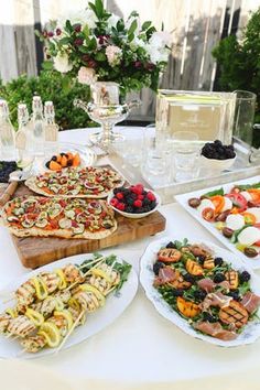 a table topped with lots of different types of food and drinks on top of it