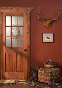 a wooden door sitting in front of a red wall