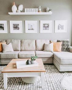 a living room filled with lots of furniture and pictures on the wall above it's coffee table