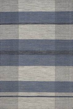 an area rug with blue and grey stripes