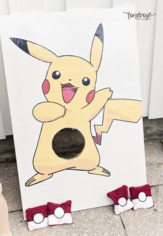 a painting of a pikachu is on the ground next to some baby shoes