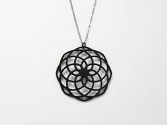 A simple, yet modern take on the classic Fibonacci number.  This mathematically created spiral pendant is gorgeous and will make a perfect gift for any women or even better for yourself.Pendant was 3D PRINTED in your choice of black nylon, 18K Gold Plated, or 14K Rose Gold.A matching flat cable chain is included with your purchase.  Chain is a standard 18" long. Geometric Black Jewelry For Gifts, Spiral Black Necklace As A Gift, Black Spiral Necklace As A Gift, Black Spiral Necklace For Gift, Modern Laser Cut Jewelry For Gifts, Black Laser Cut Jewelry As Gift, Black Laser Cut Jewelry Gift, Geometric Black Necklace For Gift, Black Geometric Necklace For Gift