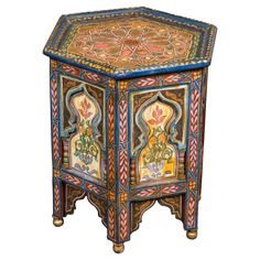 an elaborately painted wooden table with ornate designs