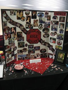 a table topped with pictures and confetti next to a wall covered in photos