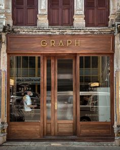 an old building with two large doors that say graph on the front and side windows