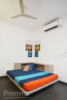 a bed sitting in the middle of a bedroom next to a ceiling fan