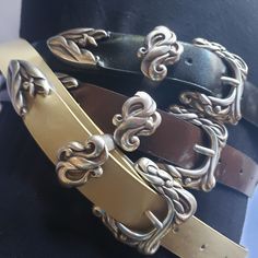 "This vintage silver ladies Wstern belt buckle set has a unique design engraved in it. This set includes one buckle one keeper and a belt tip. receive a free belt with every buckle set purchase. belts come in three colors cream, black, and brown.  sorry I only have the following size belts left 32\" in all colors and 36\" in brown only" Luxury Vintage Brass Belt Buckle, Elegant Adjustable Belt Buckles With Brass Buckle, Elegant Adjustable Belt Buckle With Brass Detail, Formal Adjustable Belt With Antique Buckle, Vintage Formal Belts With Silver Buckle, Vintage Belt Buckles With Belt For Gift, Elegant Adjustable Belts With Silver Buckle, Elegant Adjustable Belt With Silver Buckle, Elegant Brown Belt With Silver Buckle