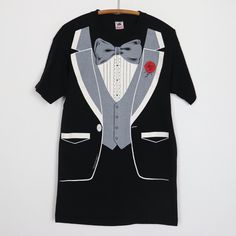 Original 1990s Tuxedo Costume Shirt. This is a true vintage shirt, not a modern reproduction. Sizes vary so please use measurements for best idea on fit. No back graphics. Shirt is in excellent condition, no holes, no stains. This shirt comes laundered and ready to wear. Tag Size: Large Material: 100% Cotton Pit to Pit: 20.5 inches Collar to Hem: 30.5 inches Retro Formal Cotton Tops, Black Formal Shirt With Graphic Print, Vintage Cotton T-shirt For Party, Vintage Short Sleeve Party T-shirt, Vintage Graphic Print Party Tops, Vintage Graphic Print Party Shirt, Quick Halloween Costumes, Graphics Shirt, Costume Shirts