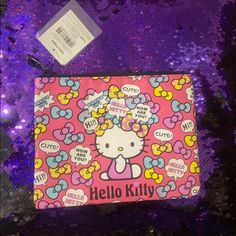 hello kitty makeup bag on purple sequins with name tag and price tag attached