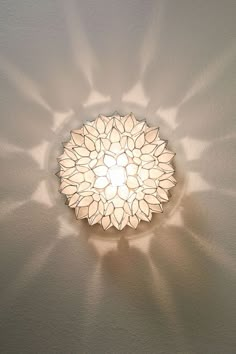 a light that is on the side of a wall in a room with white walls