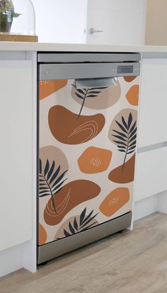 a dishwasher sitting on top of a kitchen counter next to a wooden floor