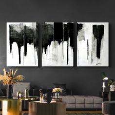 black and white paintings on the wall in a living room