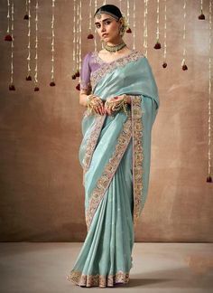 Elevate your bridal look with our sky blue saree, adorned with intricate sequins and organza silk. The elegant contrast lavender blouse, featuring intricate embroidery, adds a touch of sophistication to your wedding ensemble. Perfect for the stylish bride looking to make a statement. The unstitched blouse can be customized upto 44 inches. Do Note: All the accessories shown are for styling purpose only. Slight color variation may occur due to photographic reasons. Fall and Pico : Done Draping Sar Saree Matching Blouse, Drapping Saree, Sequins Saree, Blue Organza, Saree Embroidery, Organza Silk Saree, Designer Silk Sarees, Embroidered Organza, Blue Saree