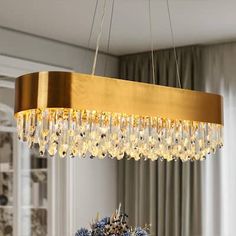 a chandelier hanging from a ceiling in a dining room with blue and white decor