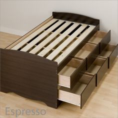 a bed with drawers underneath it on the floor