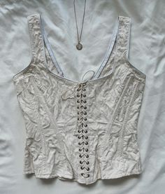 "Rare Vintage Gigi Clark ivory floral corset top, lace up. Cotton. Hook and eye closure. size S, pit to pit 34\", waist 26\", length 20.5\". very good vintage condition, slight discoloration due to age. not very noticeable" Beige Boned Bodice Sleeveless Corset, Beige Sleeveless Corset With Boned Bodice, Spring Fitted Corset With Hook And Eye Closure, White Underbust Top With Boned Bodice, Beige Sleeveless Top With Boned Bodice, Fitted Cream Top With Boned Bodice, Fitted Beige Spring Corset, Spring Beige Fitted Corset, Spring Overbust Lace-up Corset