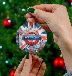 someone holding up a badge with the word underground on it in front of a christmas tree