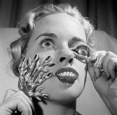 a woman with fake nails on her face