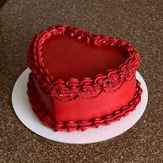 a heart shaped cake sitting on top of a white plate