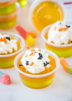 small plastic cups filled with candy and whipped cream