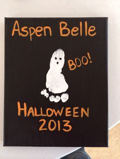 a wooden sign that says aspen belle boo halloween 2013 with a ghost on it