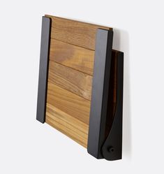 a close up of a wooden wall shelf with black metal brackets on it's sides