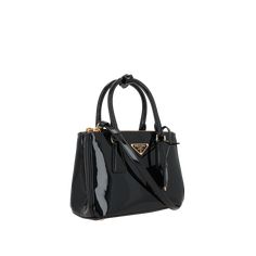 The Galleria Mini Patent Leather Handbag by PRADA is a galleria mini patent leather handbag crafted to the highest standards, offering both style and functionality.