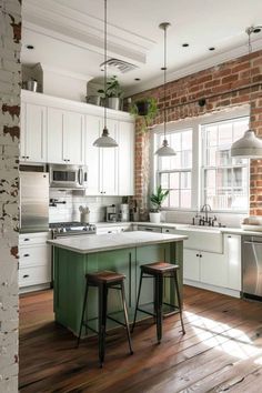 an open kitchen with brick walls and white cabinetry, two stools in front of the island